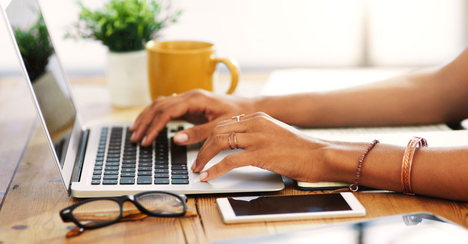 A consumer using a laptop at their desk