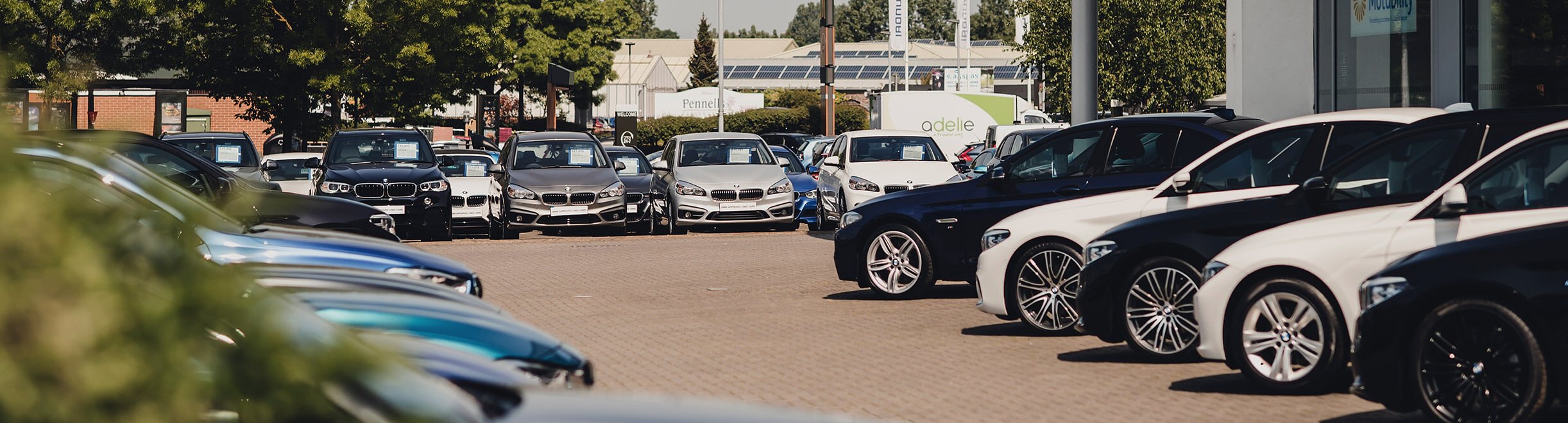 A dealership forecourt with a large number of vehicles