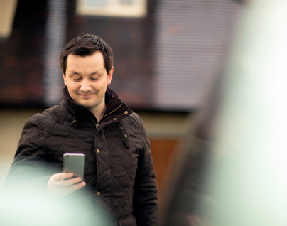 Competitive advertising rates A customer viewing their advertised vehicles on a smartphone via Autotrader