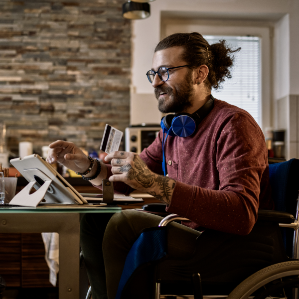 We welcome over 1,000,000 in market browsers daily A consumer holding a credit card whilst browsing Autotrader via a digital device