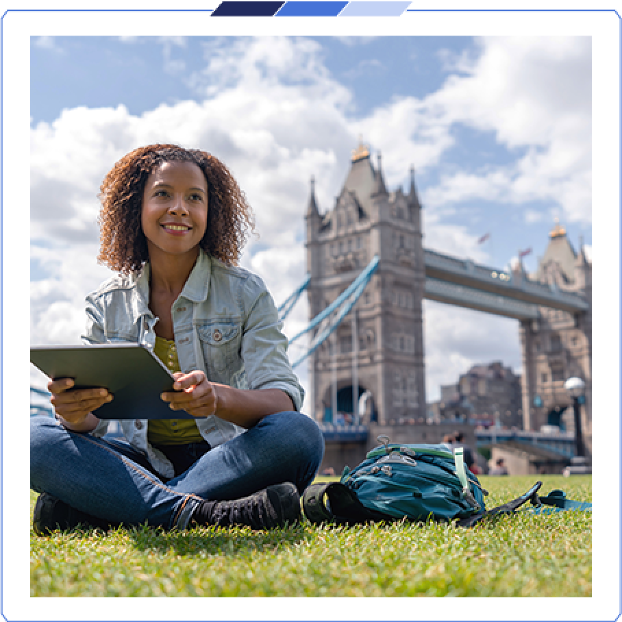 Market Extension A customer sat on a field holding an iPad with the London Bridge in the background