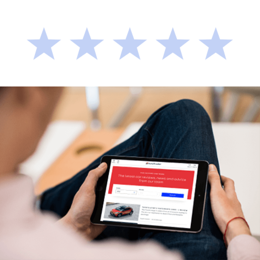 Reviews A man with a tablet on his lap looking at the Autotrader site.